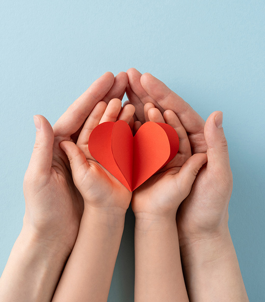 Paper hearts in a child's hands.